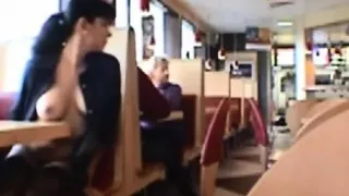 Dark haired girl flashing boobs in public restaurant