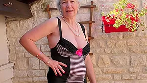 Short haired mature amateur granny Caroline strips in the garden