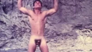 Beautiful vintage boy wanders the beach in the nude