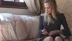 Elegant blonde MILF babe Eve strips and strokes her pussy