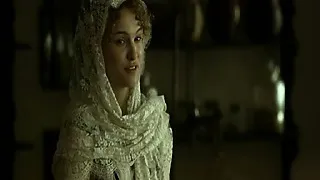 Natalie Portman lying naked on her side on some hay on the