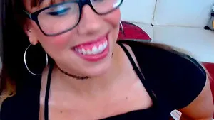 Adorable babe with glasses and nerdy look in her eyes and teeth