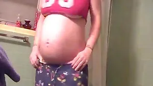 Sexy pregnant housewife dances in the shower for hubby