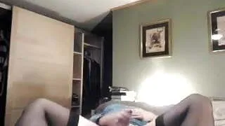 Cindi jerks off on bed.