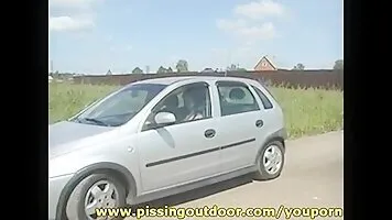 Violetta pisses near the car