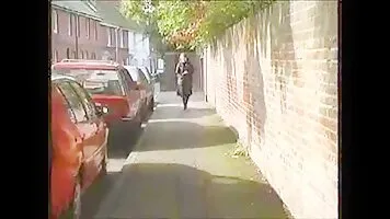 Woman in boots pissing in the street