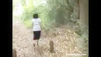 Woman peeing in the bushes