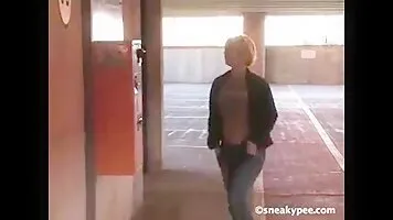 Woman peeing in the parking lot