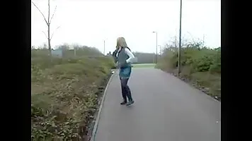 Woman pissing on the sidewalk