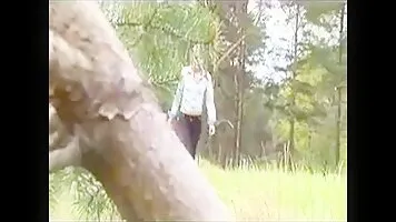 Young girl pissing on the lawn