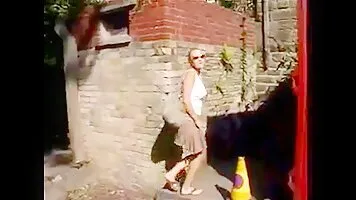 Sexy blonde pee in a quiet courtyard