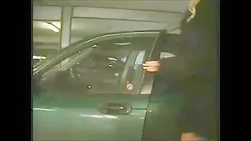 Pissing girl sitting on the hood of the car