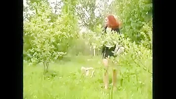Redhead chick pissing on a newspaper