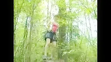 Redhead girl shows tits and pissing in the woods