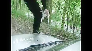 Girl liquid shitting on a white car hood