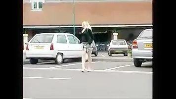 Girl pee near the car in the parking lot