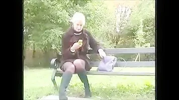 Girl pissing around bench