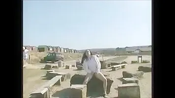 Girl pissing near the beach