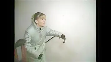 Girl in a gray raincoat pissing on the stairs