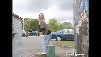 Cool blonde pissing behind dumpster