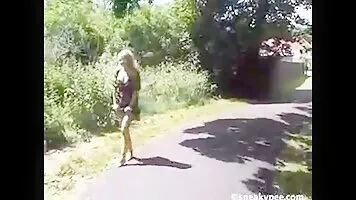 Cute girl peeing near footpath