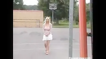 Drunk girl pissing at the bus stop and shows tits