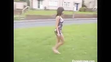 Beautiful girl pissing on the grass