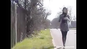 Bianca pee behind a fence