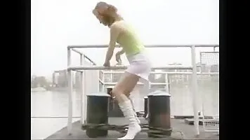 Blonde peeing and pooping from the pier