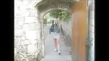 Blonde pissing on the street during the day