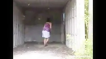 Chick pissing in an abandoned garage