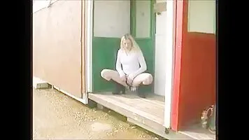 A girl in a white blouse brazenly pissing