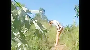 A girl with a cool figure pissing in nature