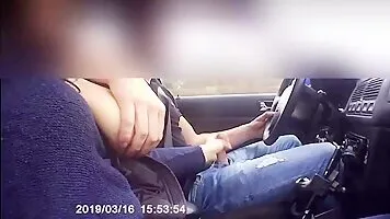 Lactating milf is jerking a hard cock in the car while driving